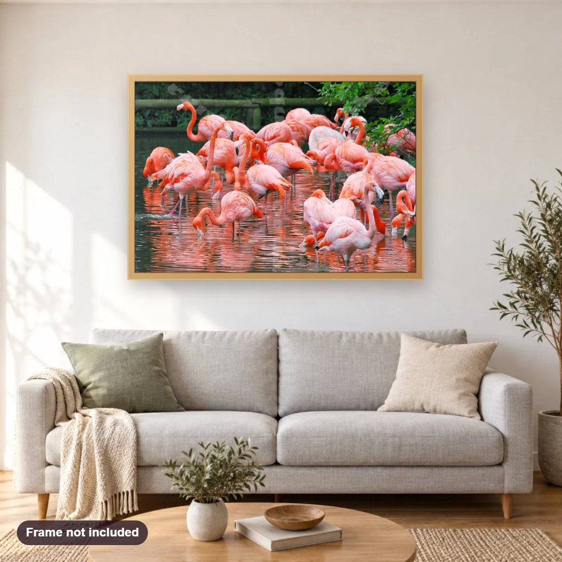 Flamingos Kingdom diamond painting shown framed on a living room wall above a sofa