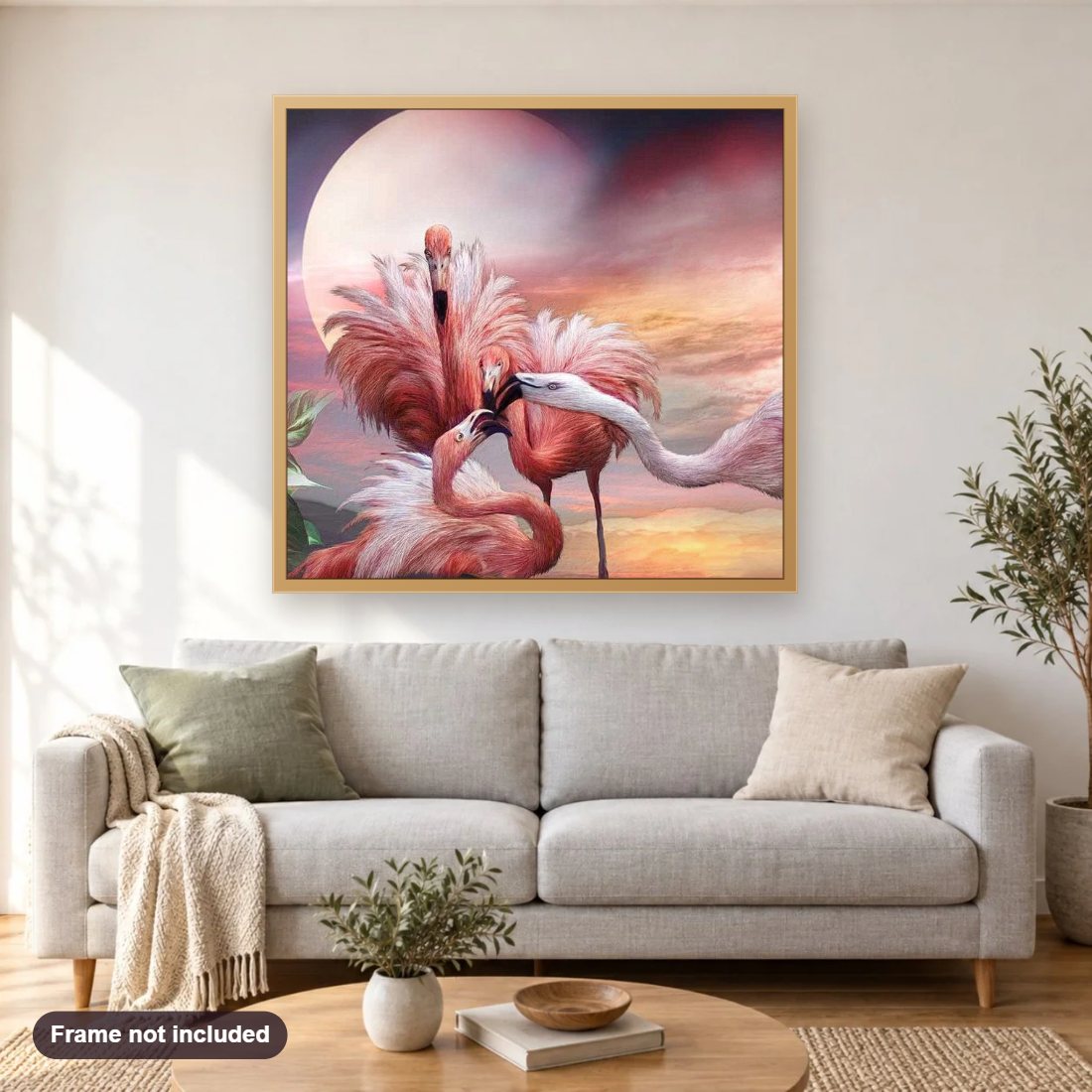 Flamingos Kiss diamond painting shown framed on a living room wall above a sofa