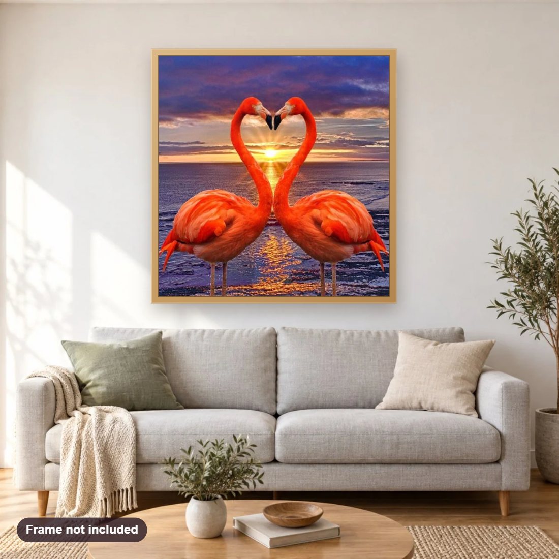 Flamingos Making Heart Shape diamond painting shown framed on a living room wall above a sofa