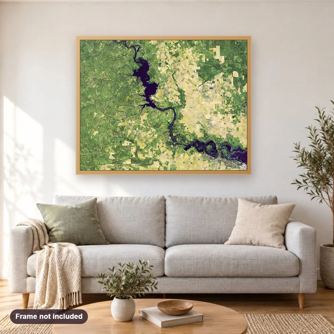 Flooding Along the Nueces River diamond painting shown framed on a living room wall above a sofa