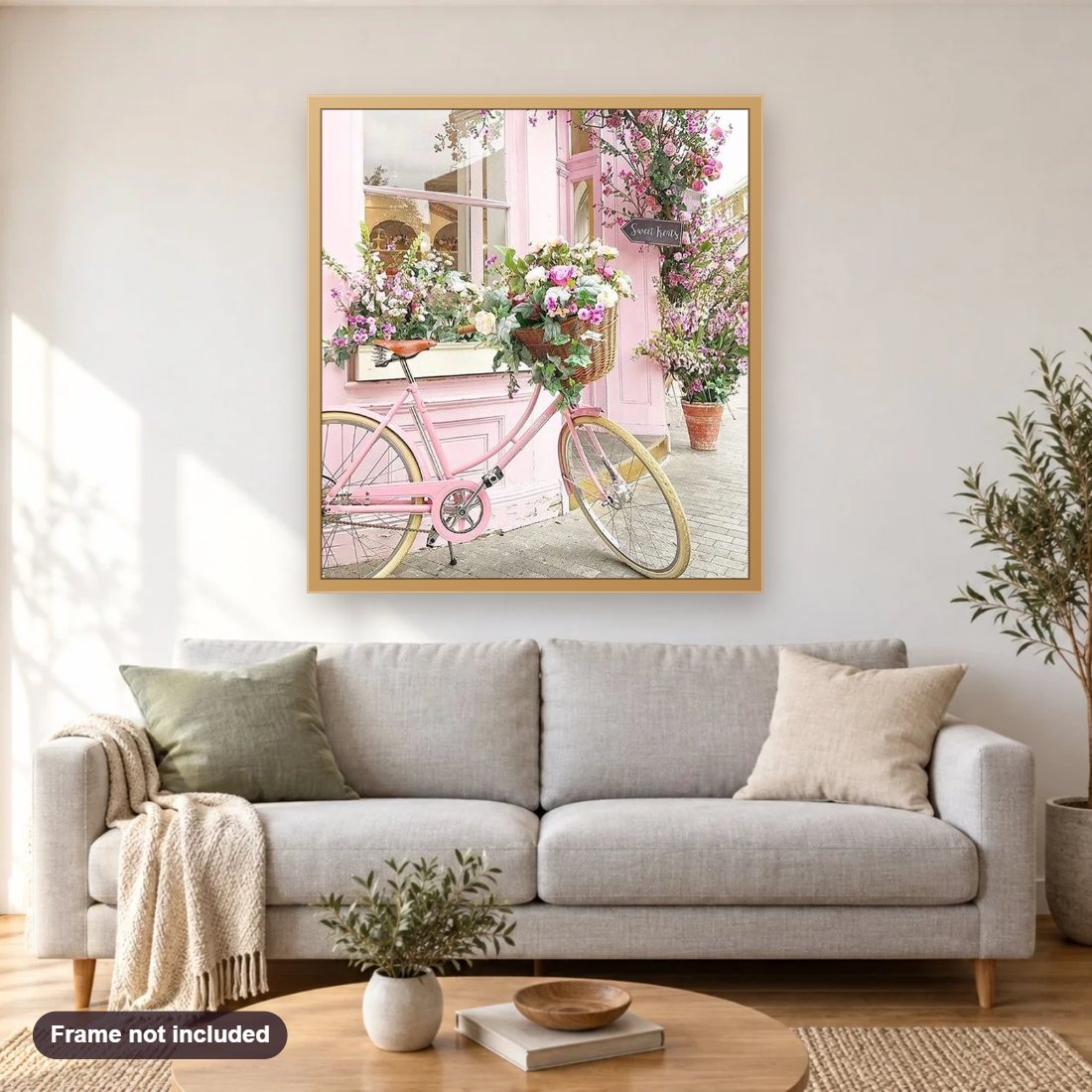 Flowers & Bicycle diamond painting shown framed on a living room wall above a sofa