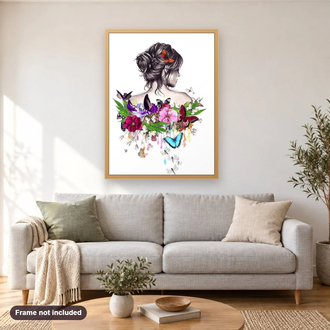 Flowers & Butterflies on her Back diamond painting shown framed on a living room wall above a sofa