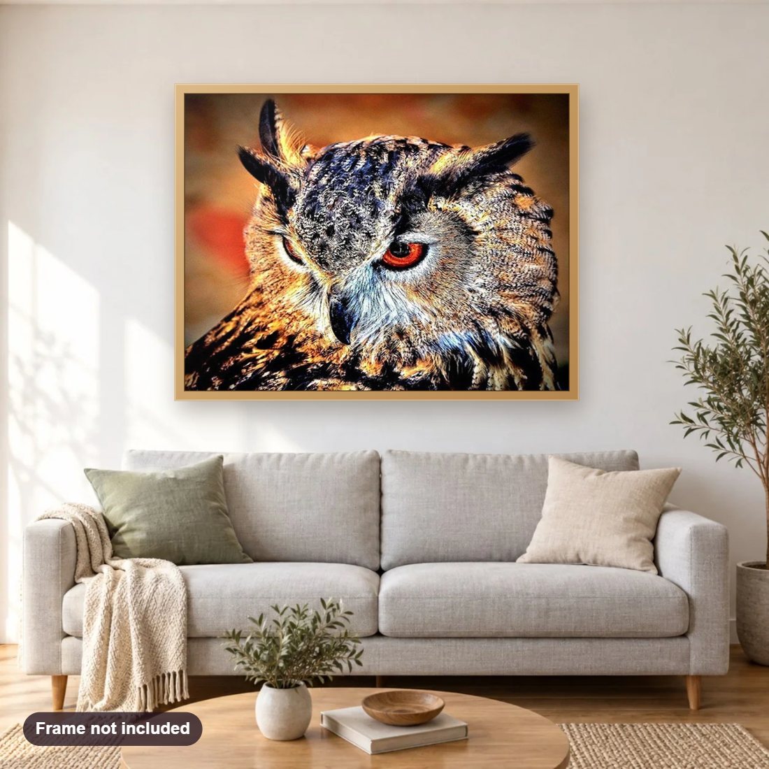 Furious Owl diamond painting shown framed on a living room wall above a sofa