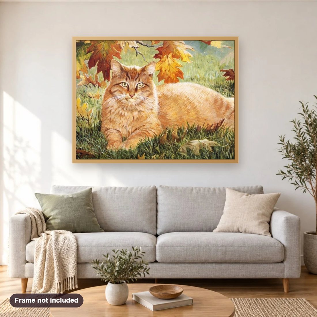 Ginger Cat diamond painting shown framed on a living room wall above a sofa