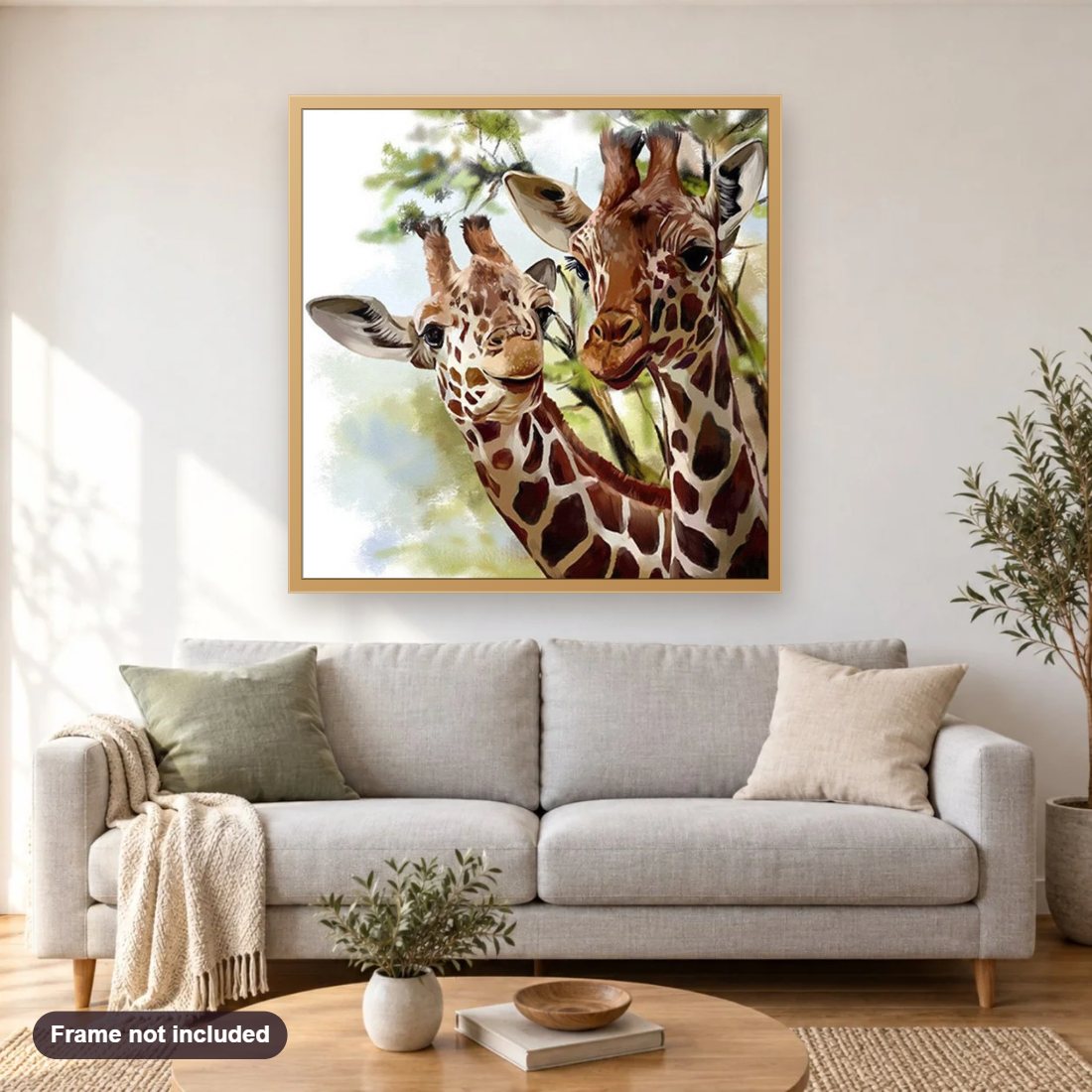Giraffe Couple diamond painting shown framed on a living room wall above a sofa
