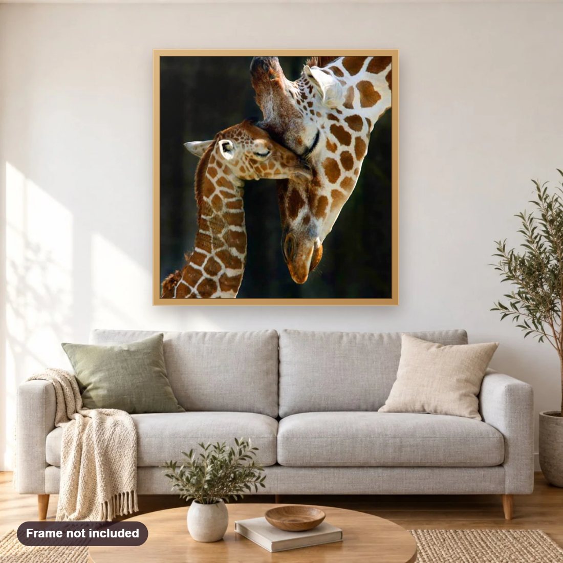 Giraffe Family diamond painting shown framed on a living room wall above a sofa
