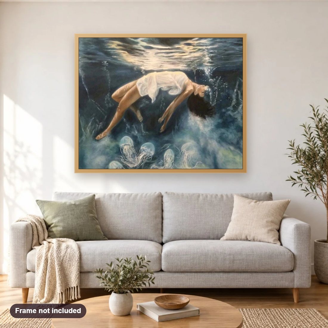 Girl Floating in Water diamond painting shown framed on a living room wall above a sofa