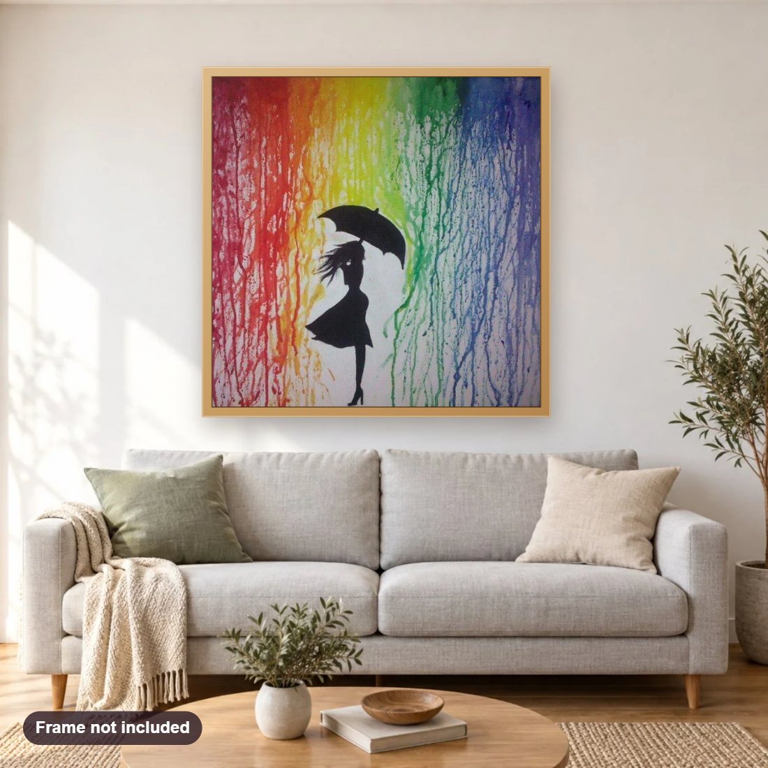 Girl in Rainbow Rain diamond painting shown framed on a living room wall above a sofa