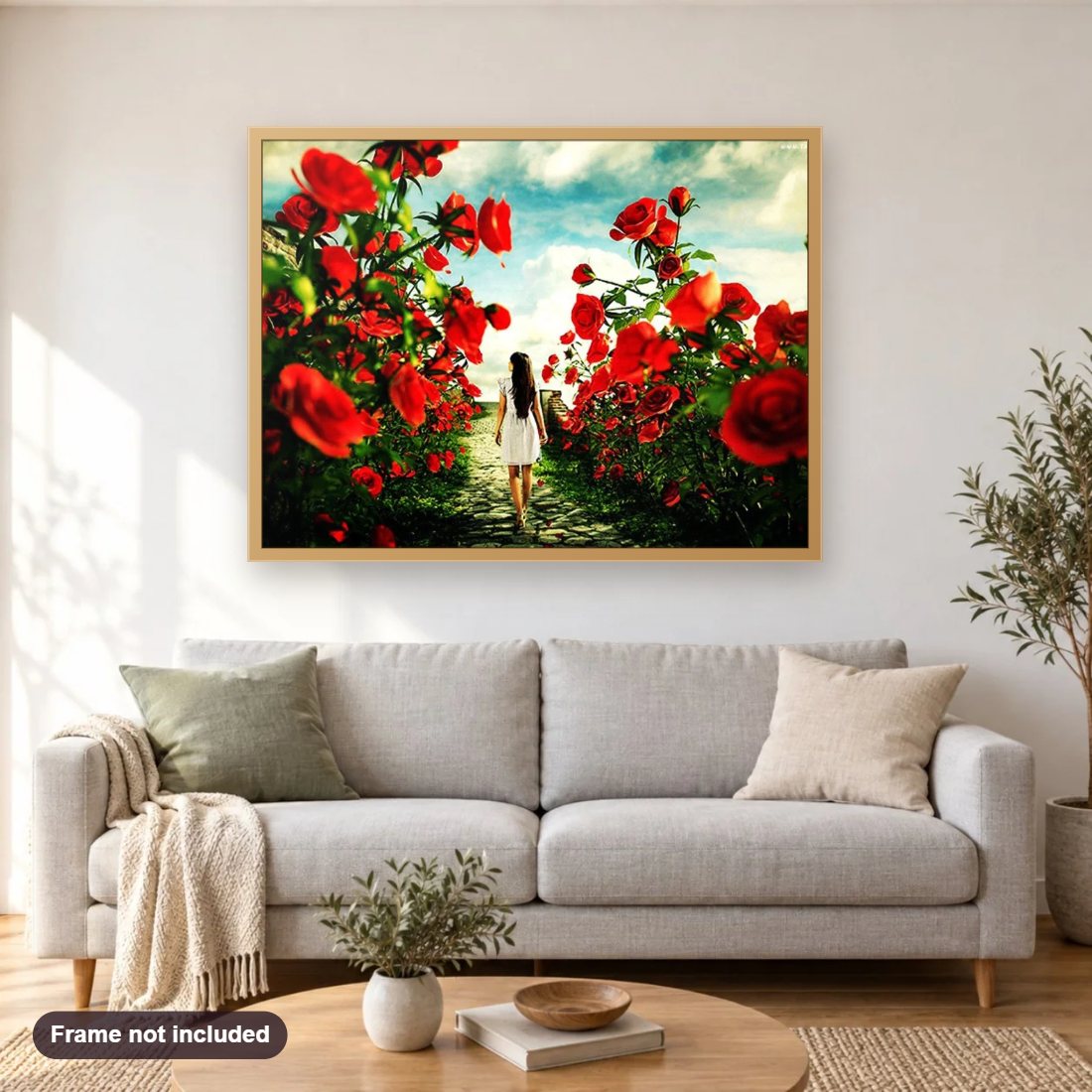 Girl Walking in Rose Garden diamond painting shown framed on a living room wall above a sofa