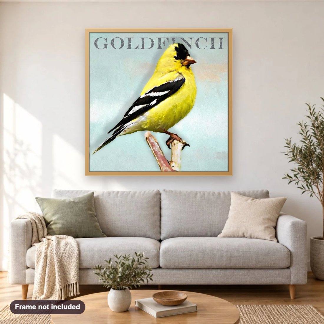 Goldfinch diamond painting shown framed on a living room wall above a sofa