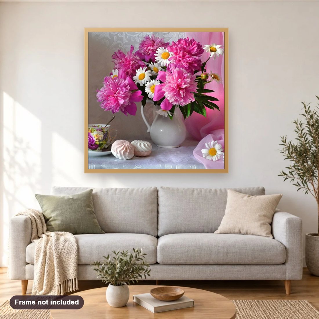 Gorgeous Pink Peonies & Daisies diamond painting shown framed on a living room wall above a sofa