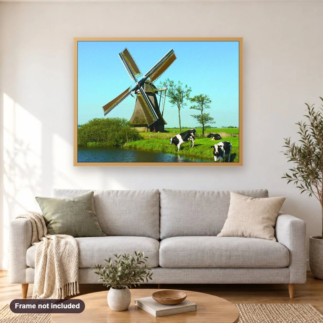 Grazing Cows & Windmill diamond painting shown framed on a living room wall above a sofa