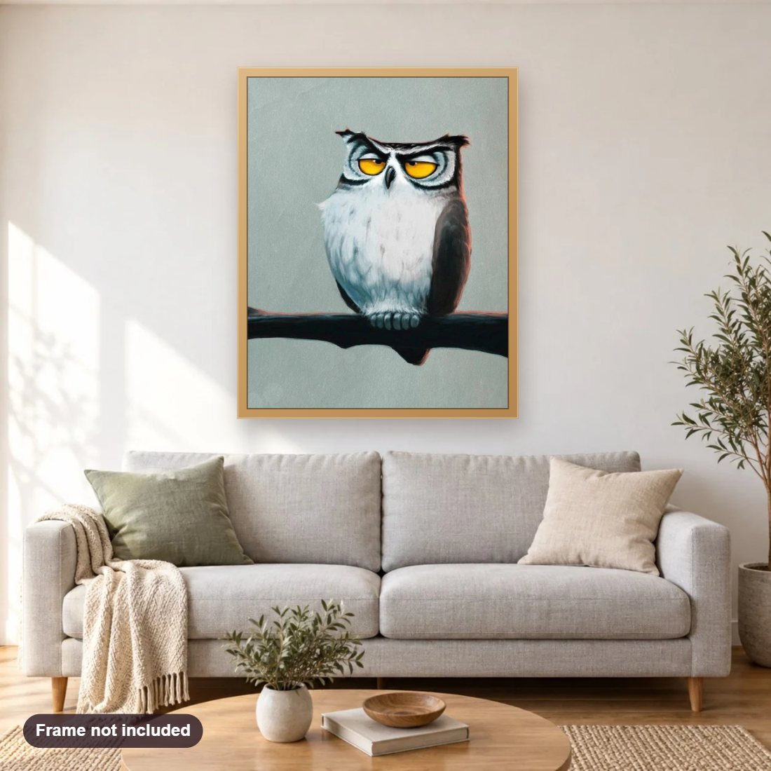 Grumpy Owl diamond painting shown framed on a living room wall above a sofa