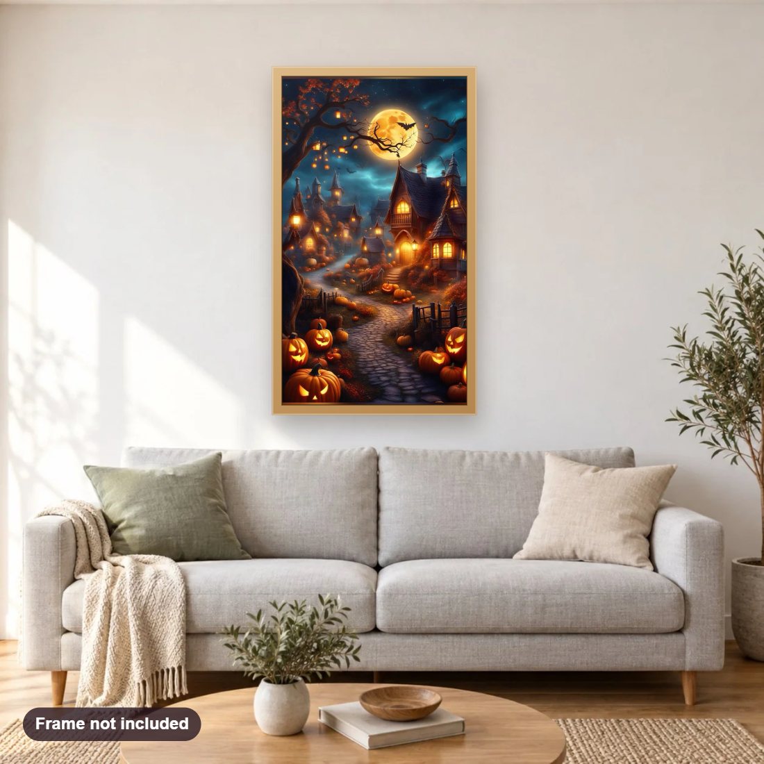 Haunted Halloween village diamond painting shown framed on a living room wall above a sofa