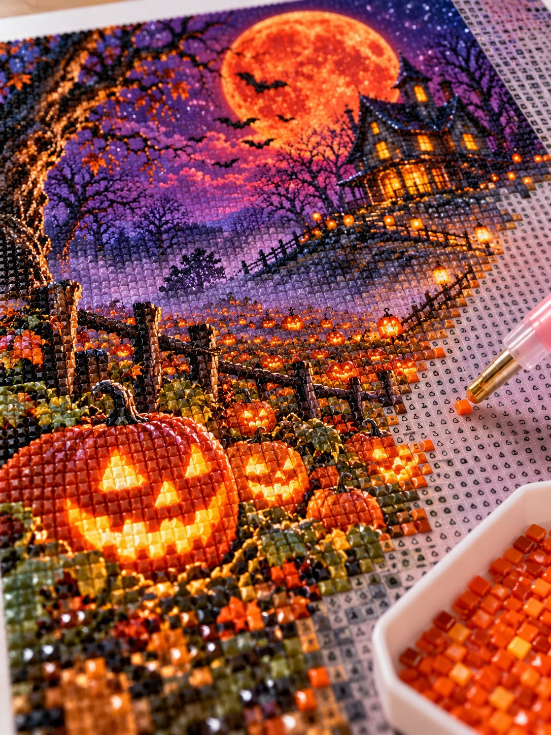 Close-up of the haunted pumpkin patch under a blood moon diamond painting in progress, square resin drills, wax pen and drill tray