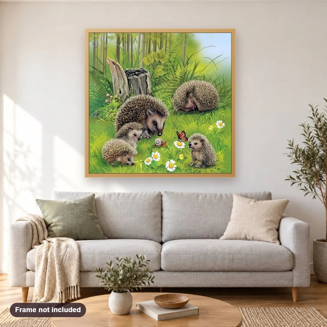 Hedgehog Family diamond painting shown framed on a living room wall above a sofa