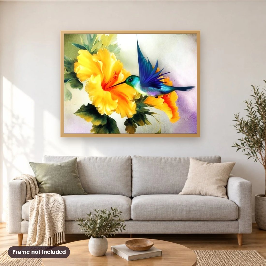 Humming Bird & Yellow Flower diamond painting shown framed on a living room wall above a sofa