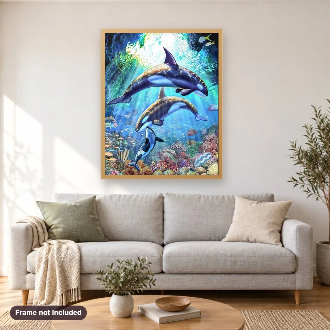 Killer Whales diamond painting shown framed on a living room wall above a sofa