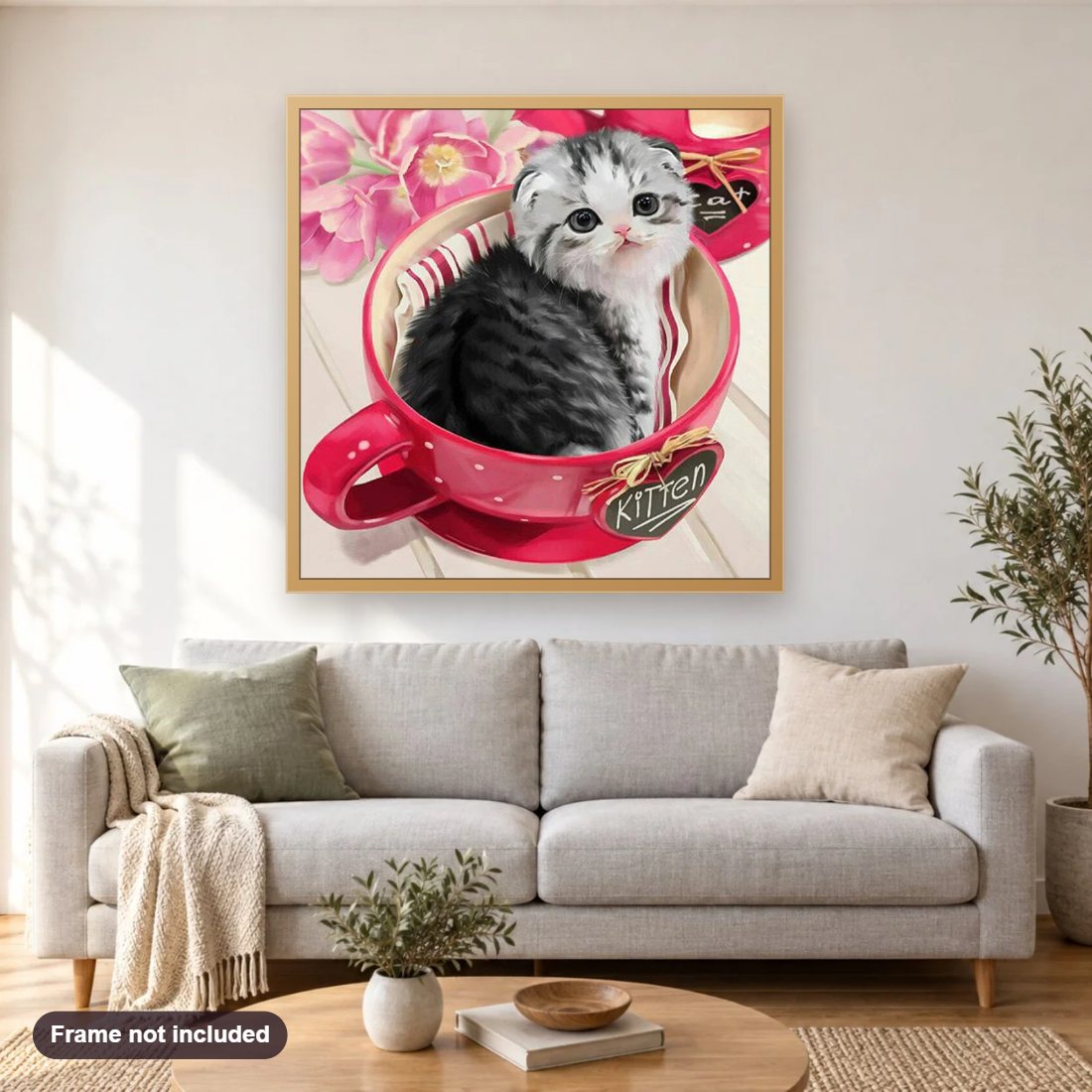 Kitten Sitting in Tea Cup diamond painting shown framed on a living room wall above a sofa