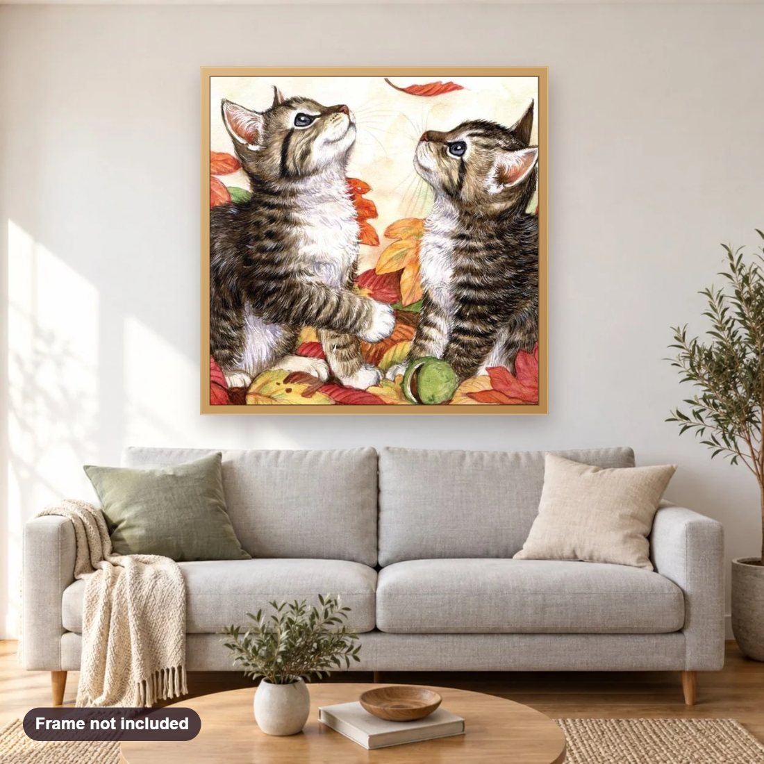 Kittens & Autumn Leaves diamond painting shown framed on a living room wall above a sofa