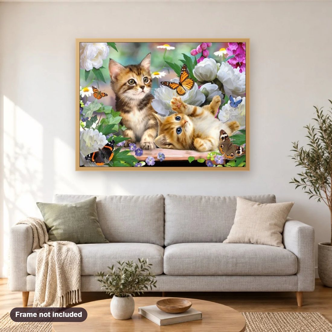 Kittens, Flowers & Butterflies diamond painting shown framed on a living room wall above a sofa