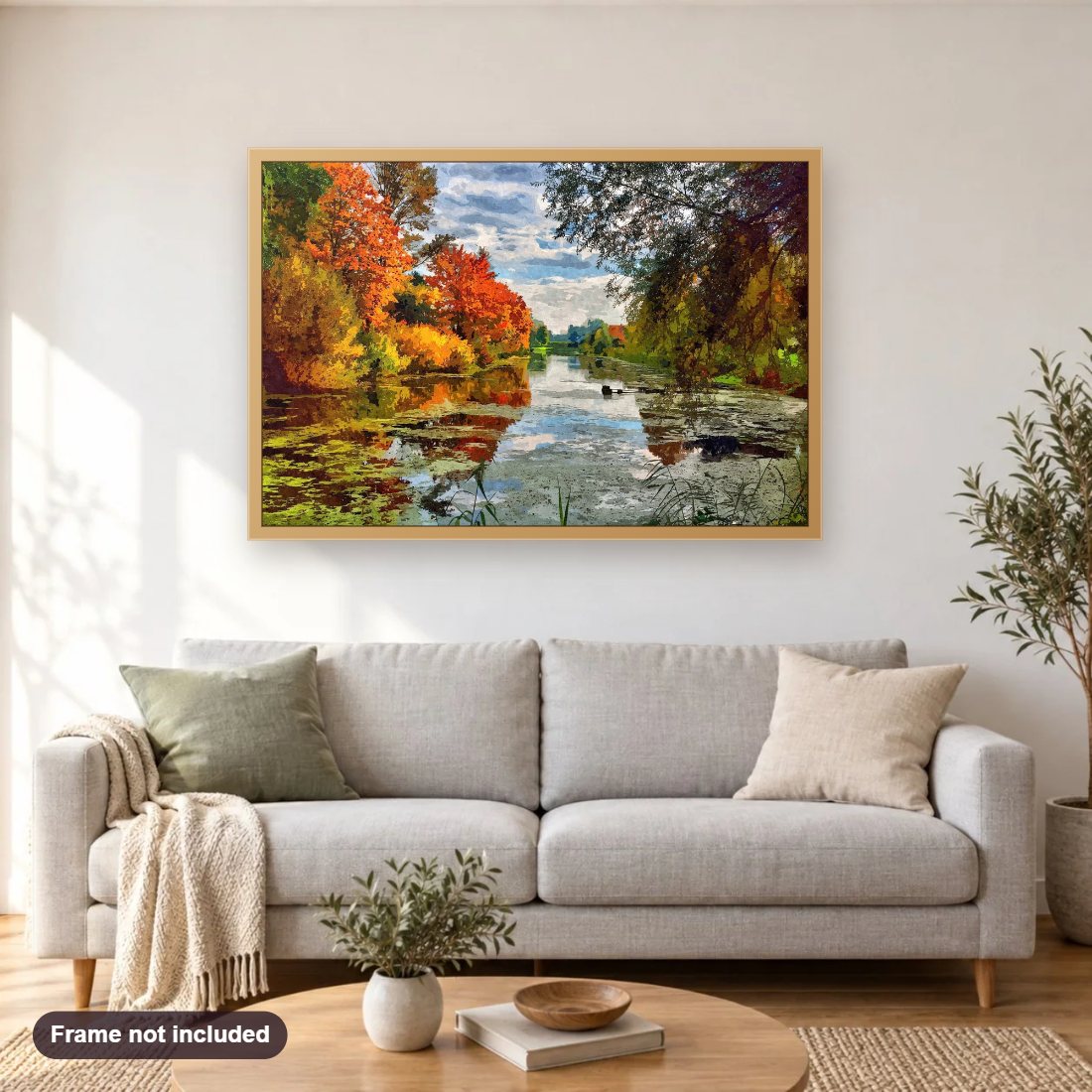 Lakeside Autumn Trees diamond painting shown framed on a living room wall above a sofa
