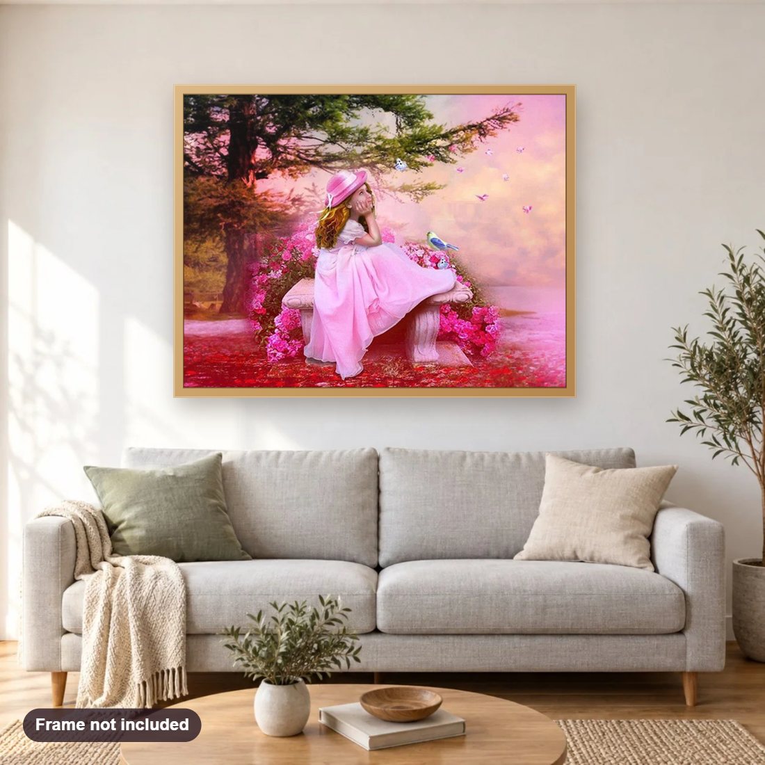Little Girl in Pink Dress diamond painting shown framed on a living room wall above a sofa