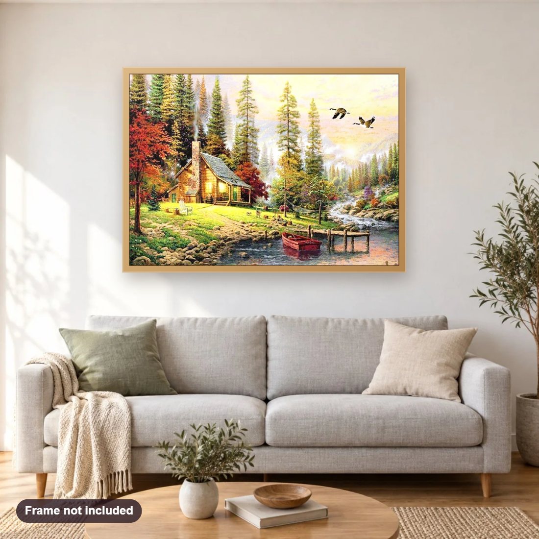 Lodge Cabin by the River diamond painting shown framed on a living room wall above a sofa