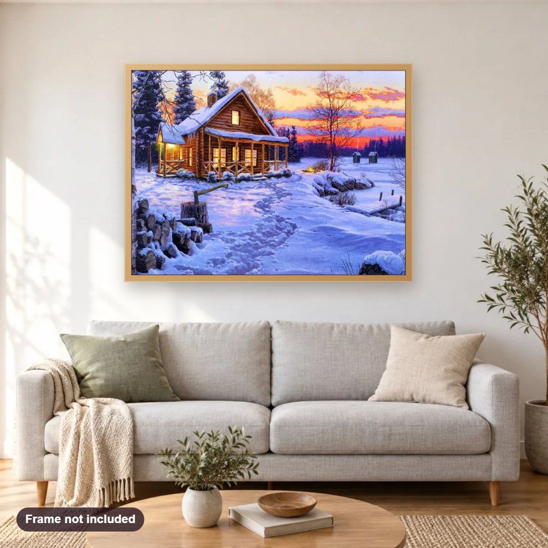 Log Cabin in Snow diamond painting shown framed on a living room wall above a sofa