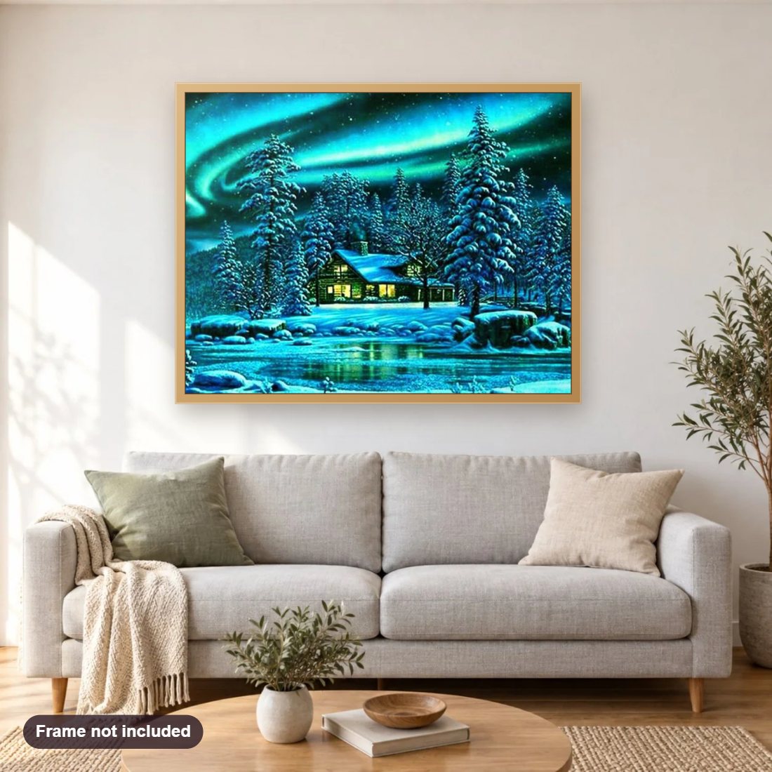 Log Cabin in the Snow diamond painting shown framed on a living room wall above a sofa