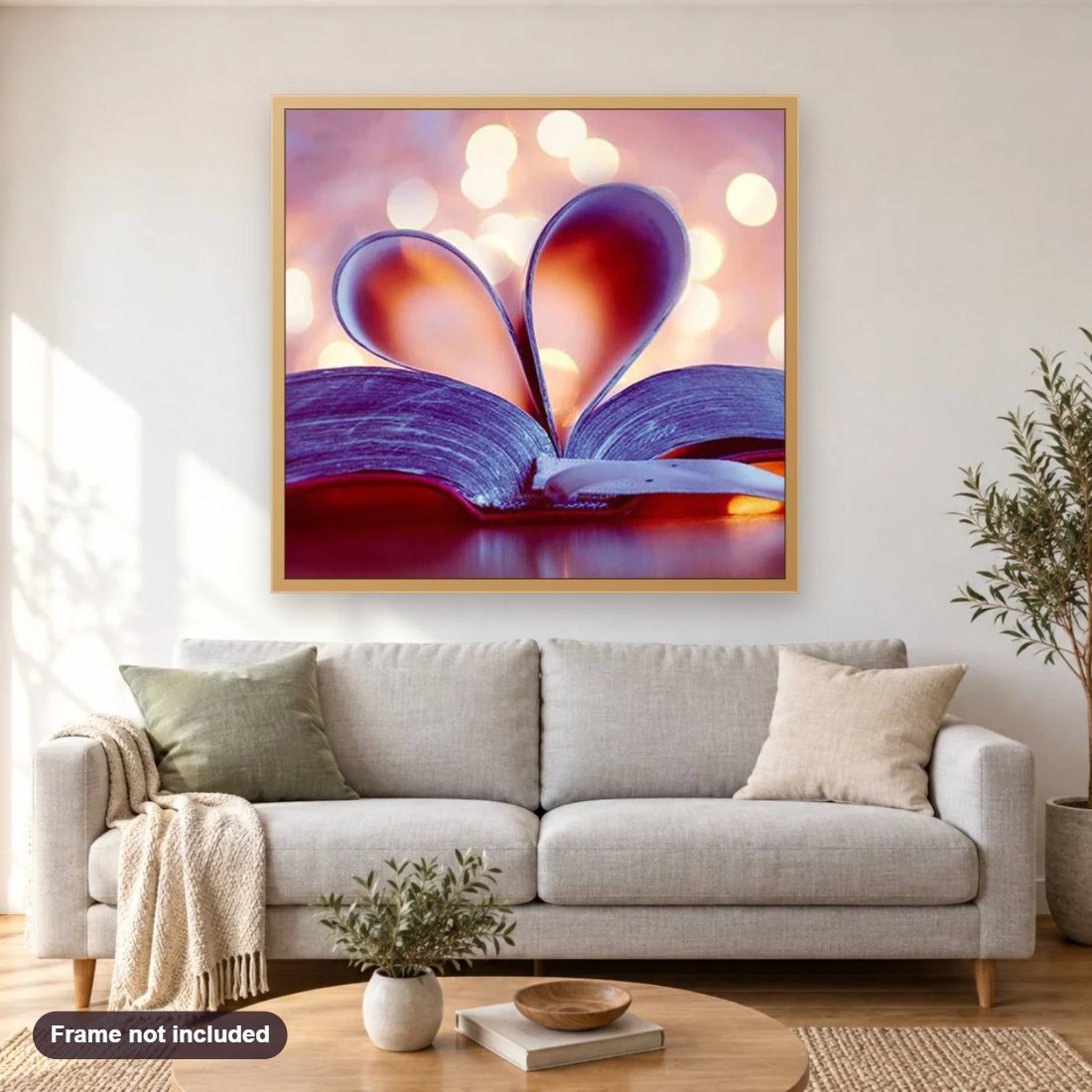 Love Book diamond painting shown framed on a living room wall above a sofa