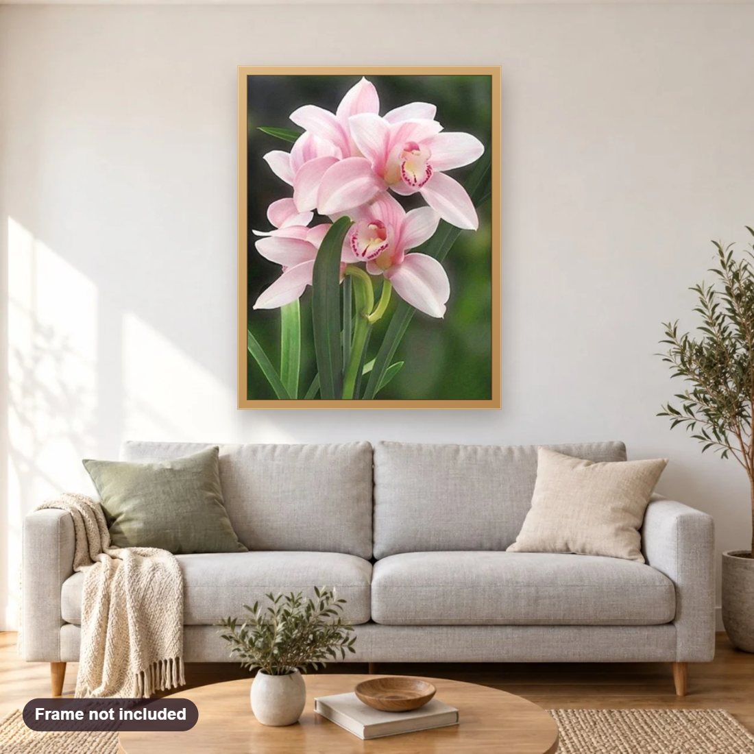 Lovely Pink Orchids diamond painting shown framed on a living room wall above a sofa