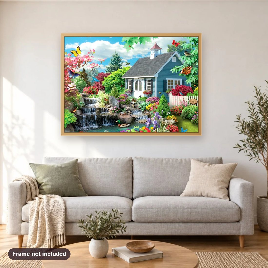 Mini Waterfall & Beautiful House diamond painting shown framed on a living room wall above a sofa