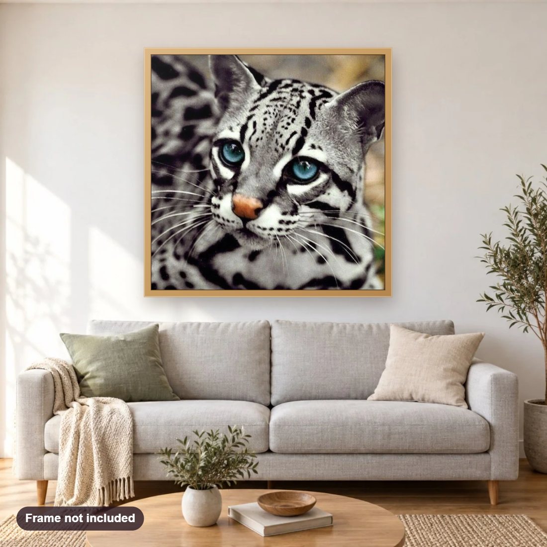 Ocelot Cat diamond painting shown framed on a living room wall above a sofa