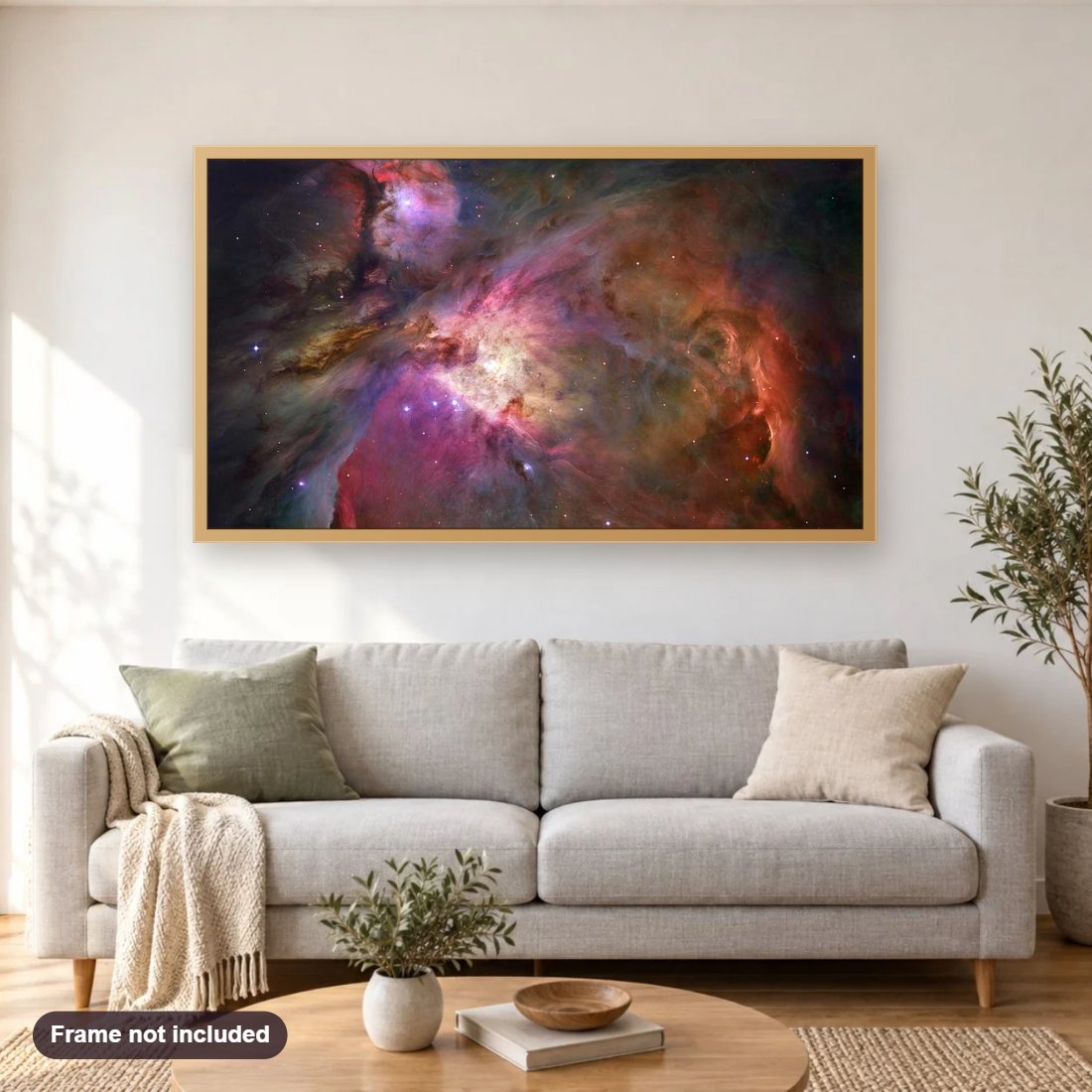 Orion Nebula diamond painting shown framed on a living room wall above a sofa