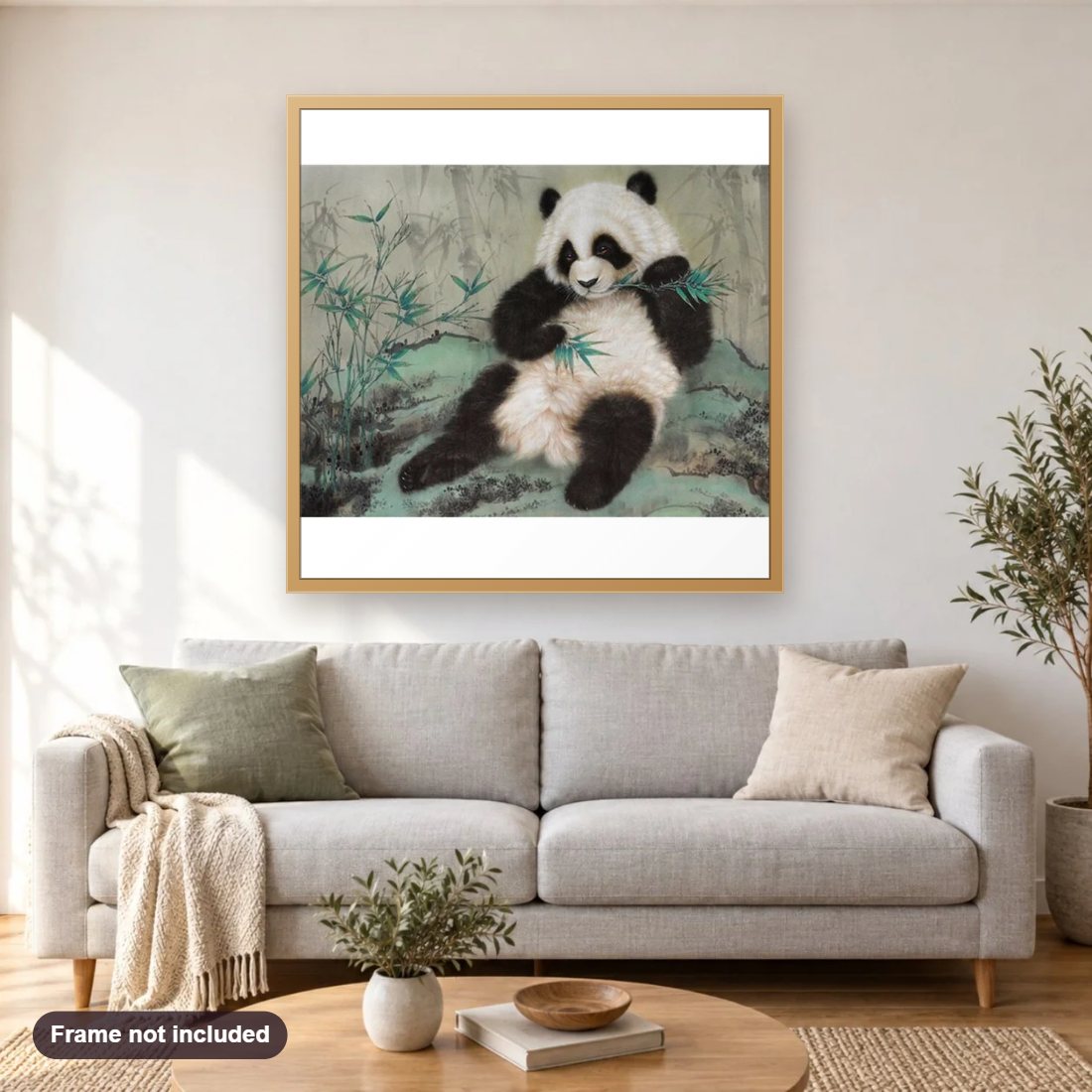 Panda Eating Bamboo diamond painting shown framed on a living room wall above a sofa
