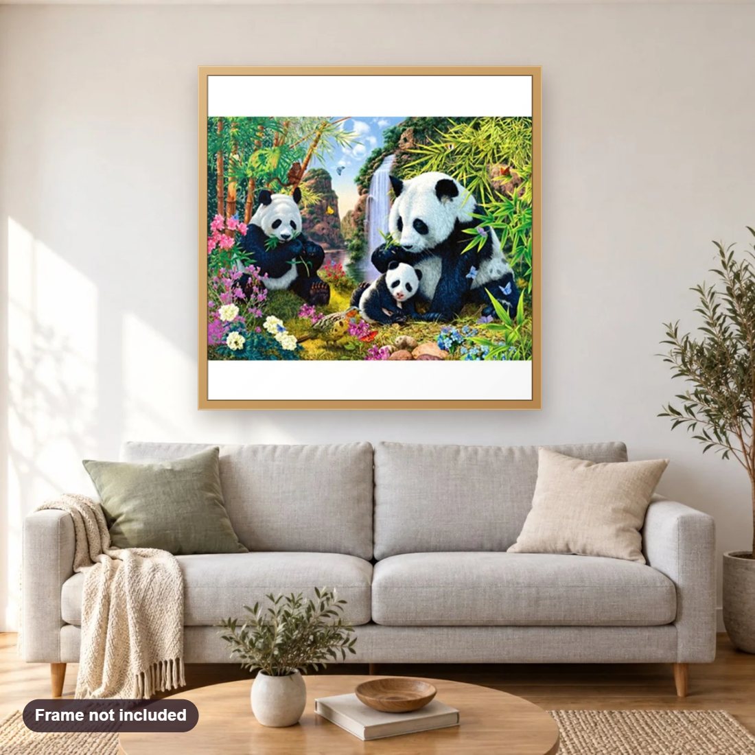 Panda Family diamond painting shown framed on a living room wall above a sofa