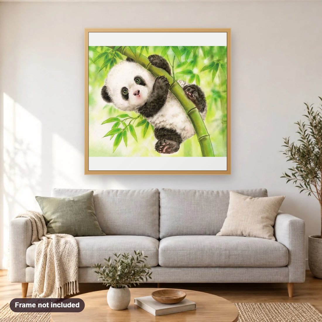 Panda Hanging On Bamboo diamond painting shown framed on a living room wall above a sofa