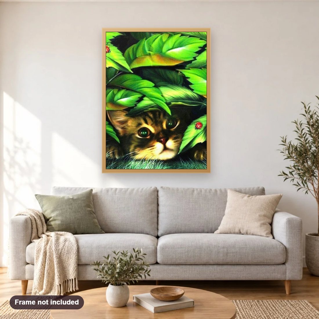 Peeping Cat diamond painting shown framed on a living room wall above a sofa