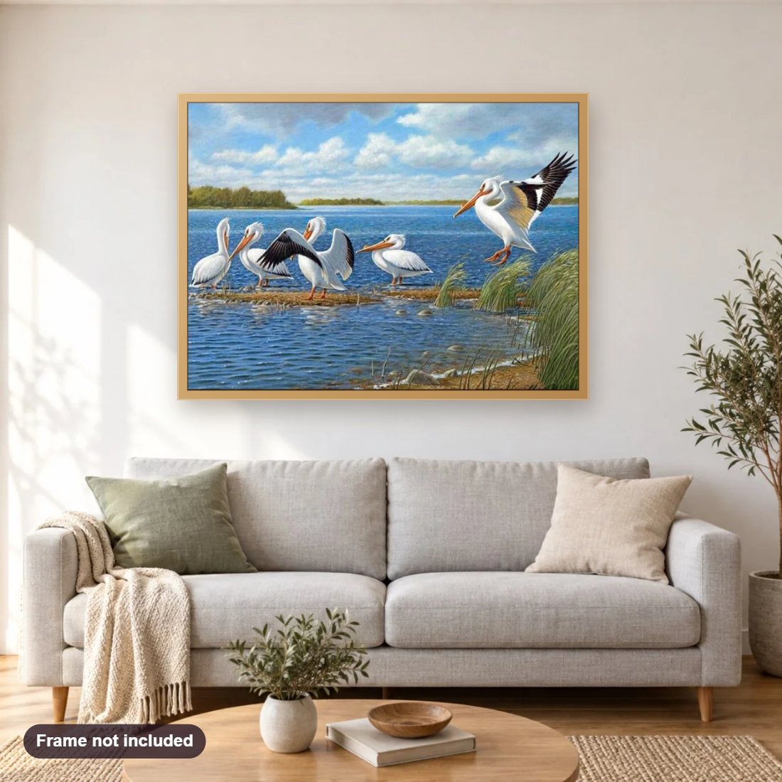 Pelicans diamond painting shown framed on a living room wall above a sofa