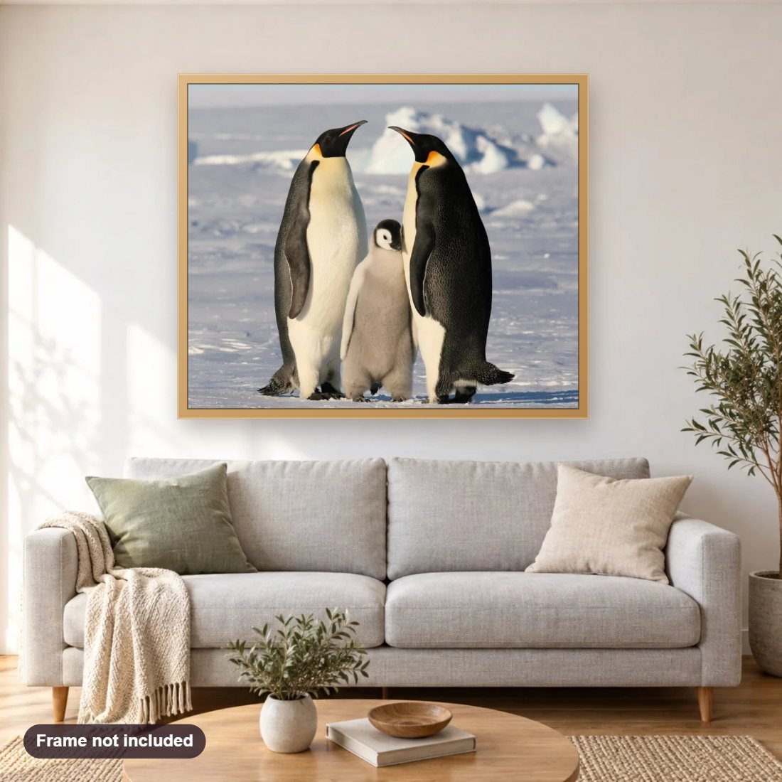 Penguin Family diamond painting shown framed on a living room wall above a sofa