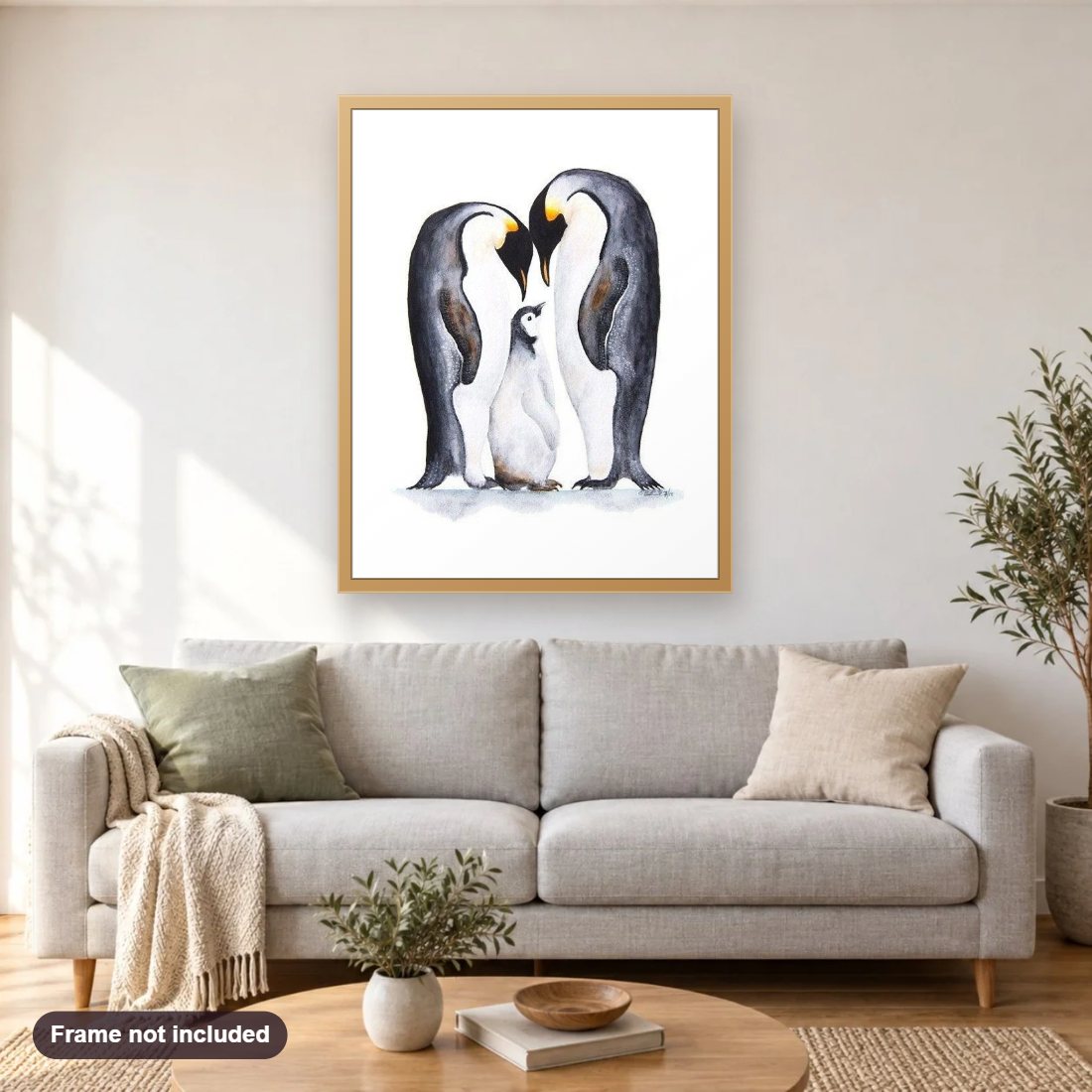 Penguins Pair with Baby diamond painting shown framed on a living room wall above a sofa