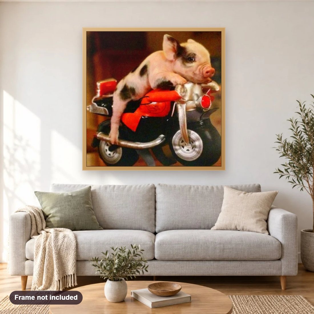 Piggy on Little Bike diamond painting shown framed on a living room wall above a sofa