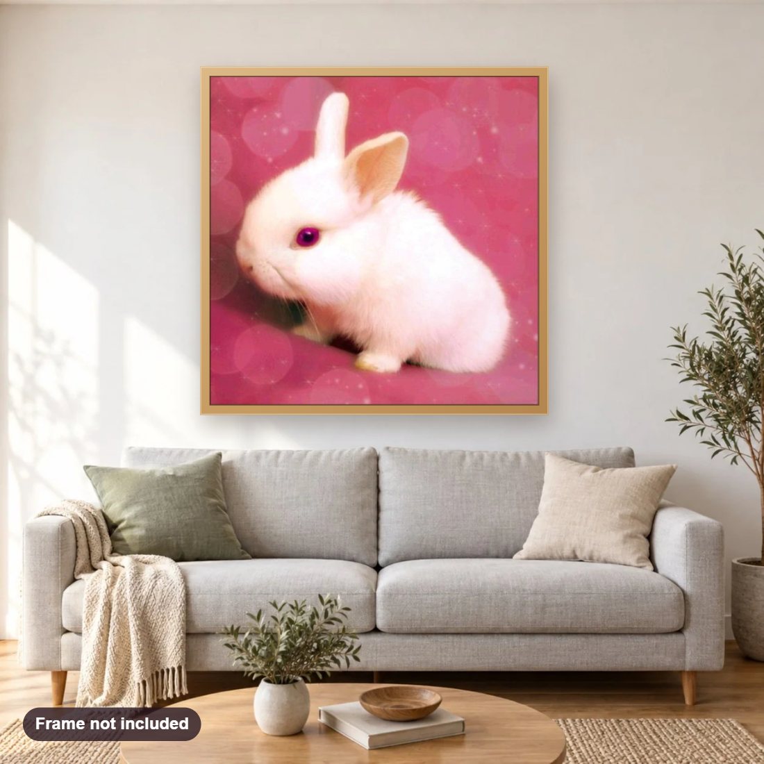 Pink Bunny diamond painting shown framed on a living room wall above a sofa