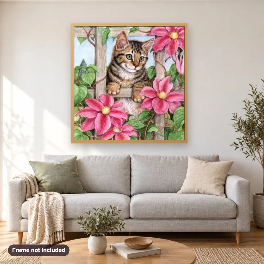 Pink Flowers & Spying Cat diamond painting shown framed on a living room wall above a sofa