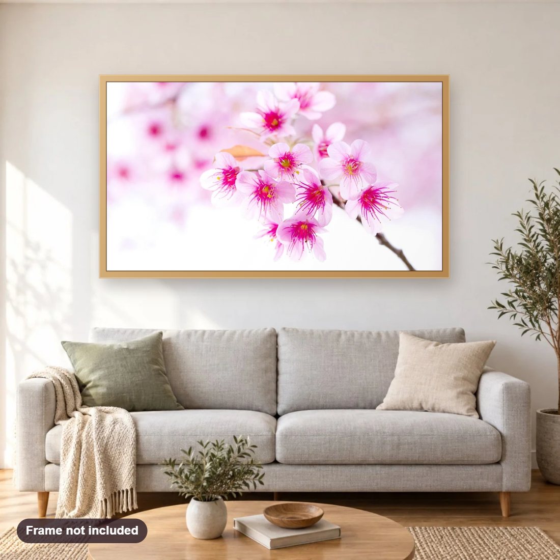 Pink Sakura Flowers diamond painting shown framed on a living room wall above a sofa