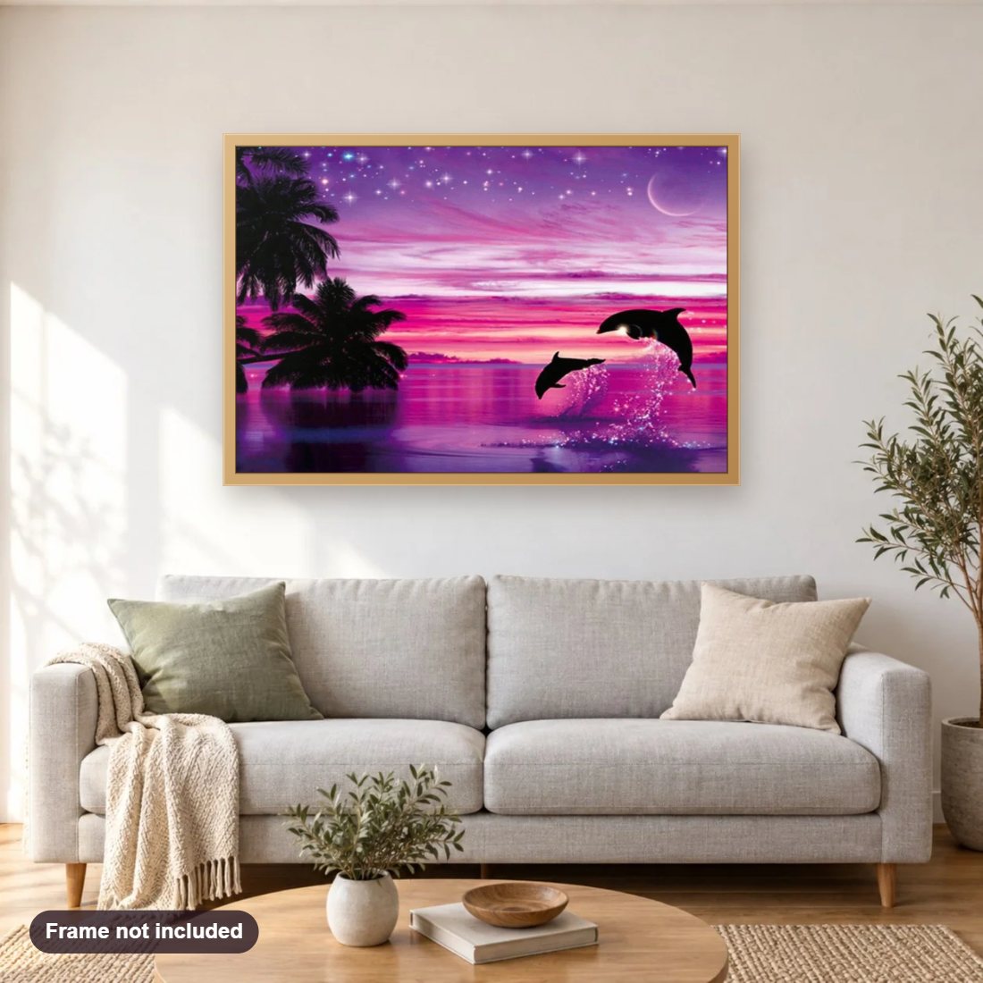 Pink Sky View & Dolphins Pair diamond painting shown framed on a living room wall above a sofa