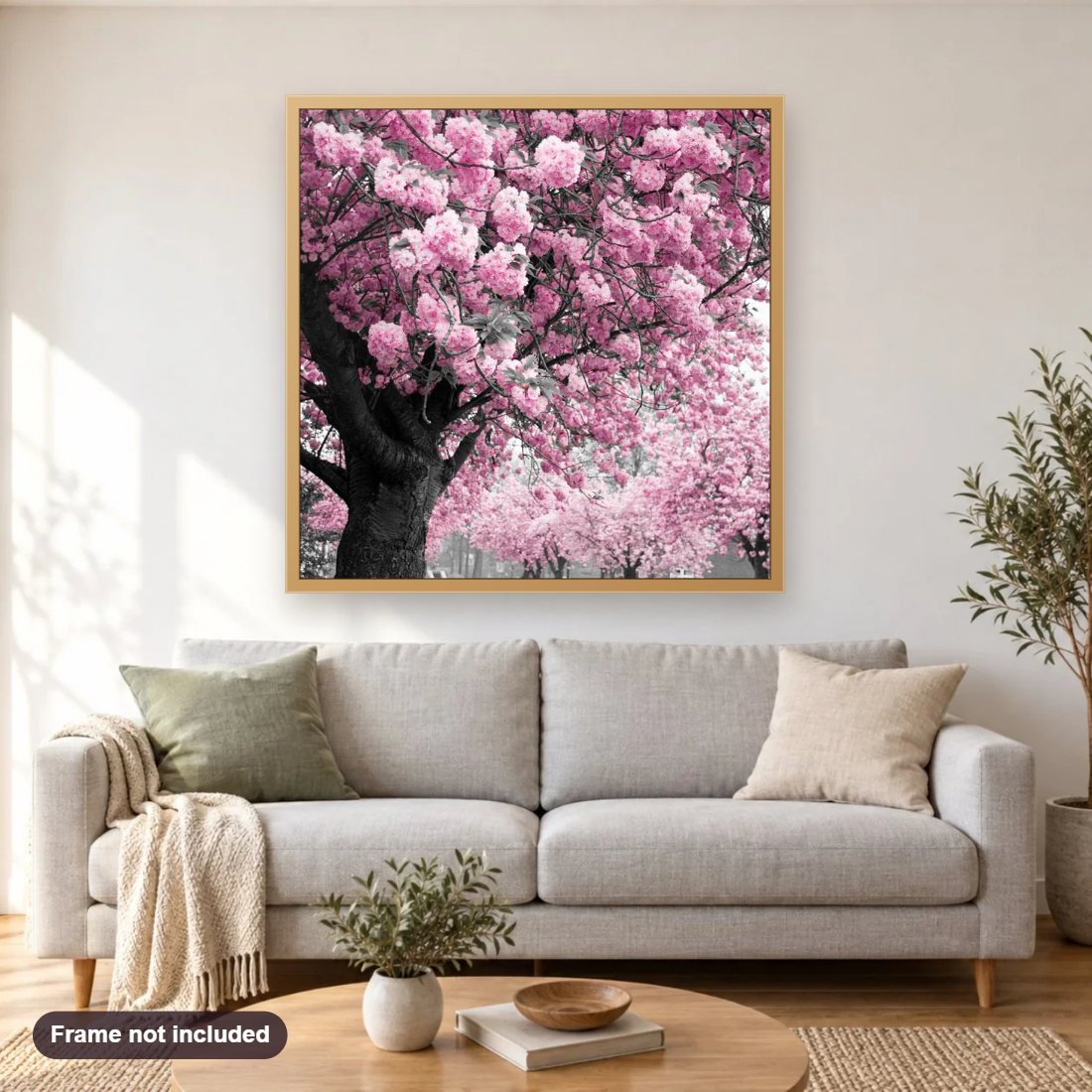 Pink Tree diamond painting shown framed on a living room wall above a sofa
