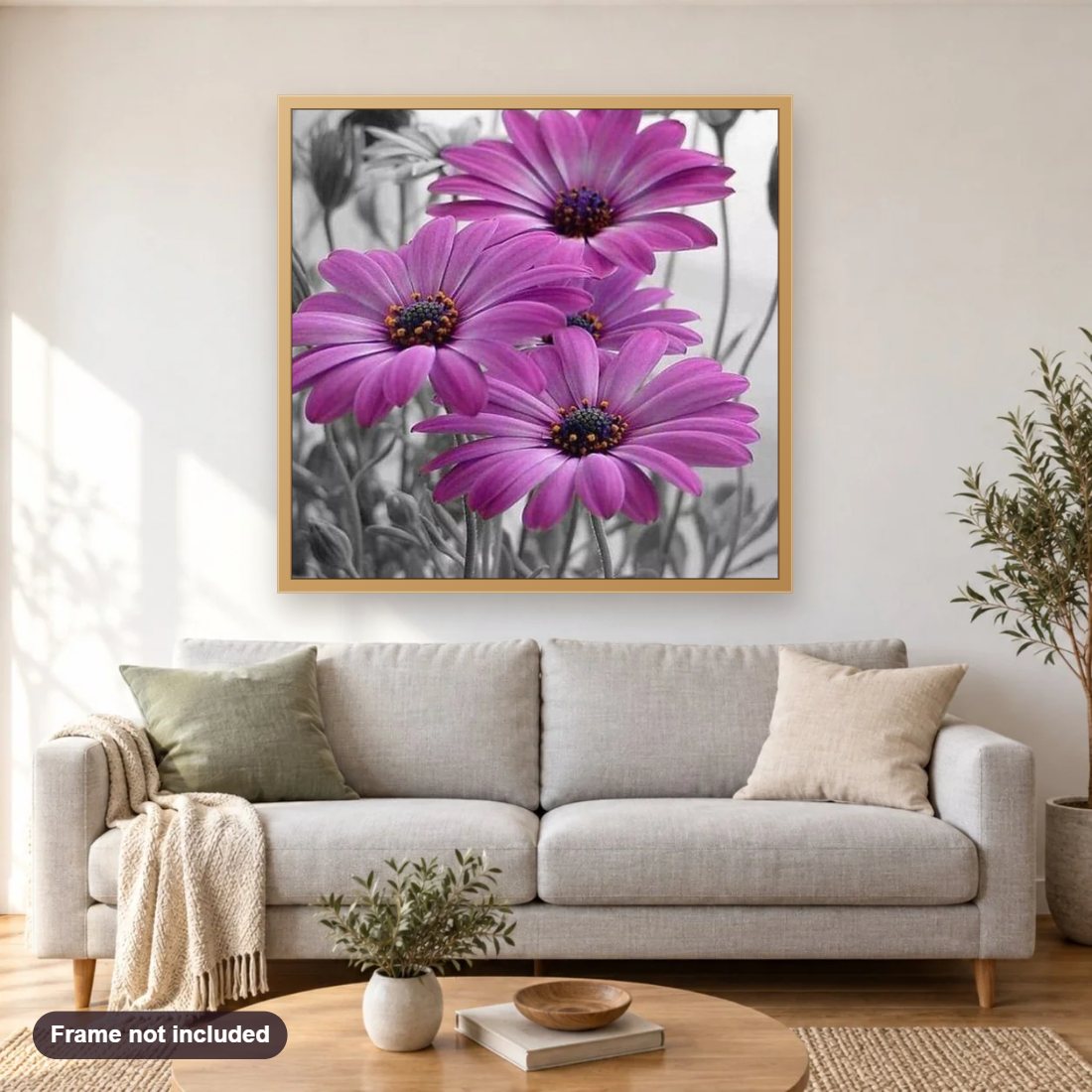 Purple Gerber Daisies diamond painting shown framed on a living room wall above a sofa