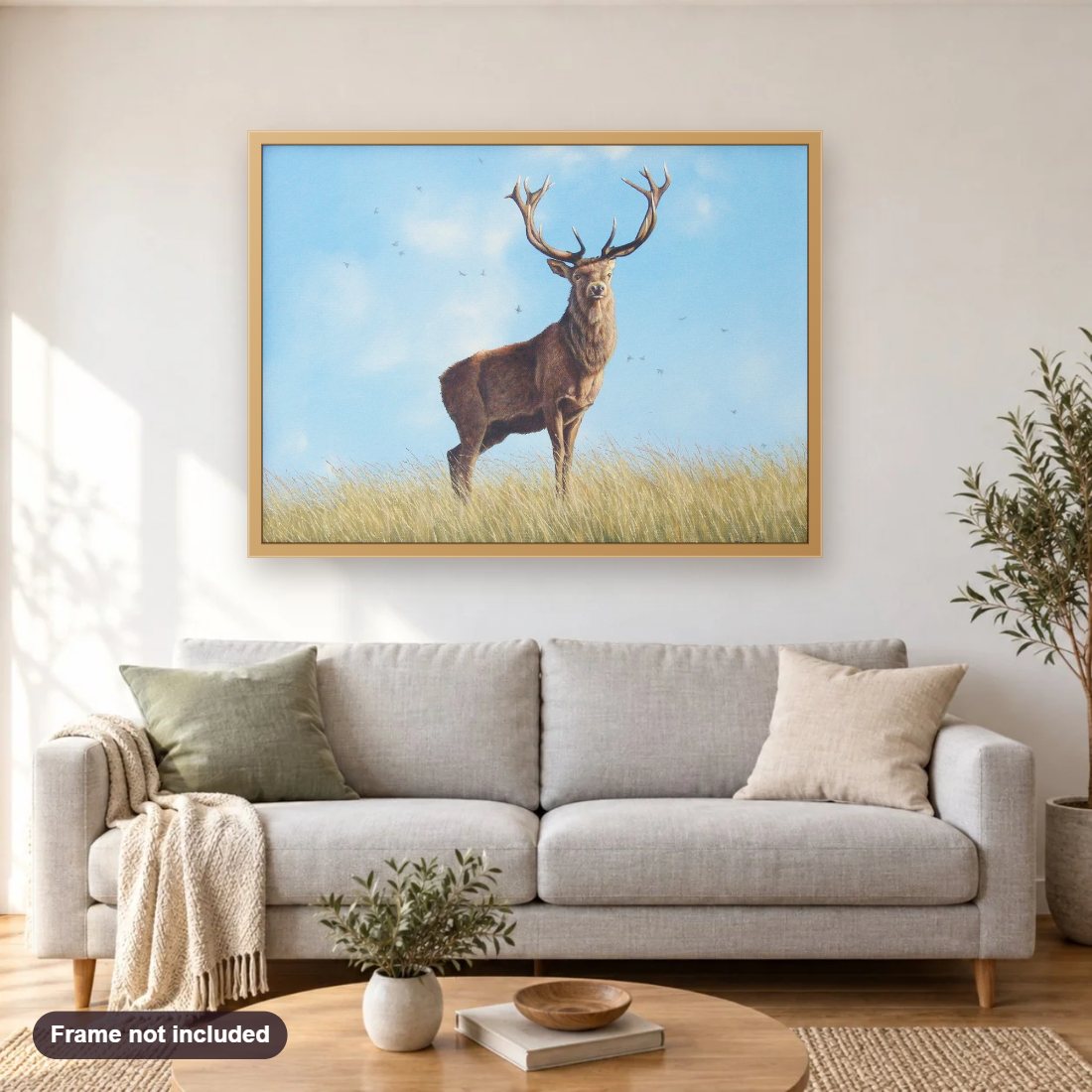 Red Deer diamond painting shown framed on a living room wall above a sofa